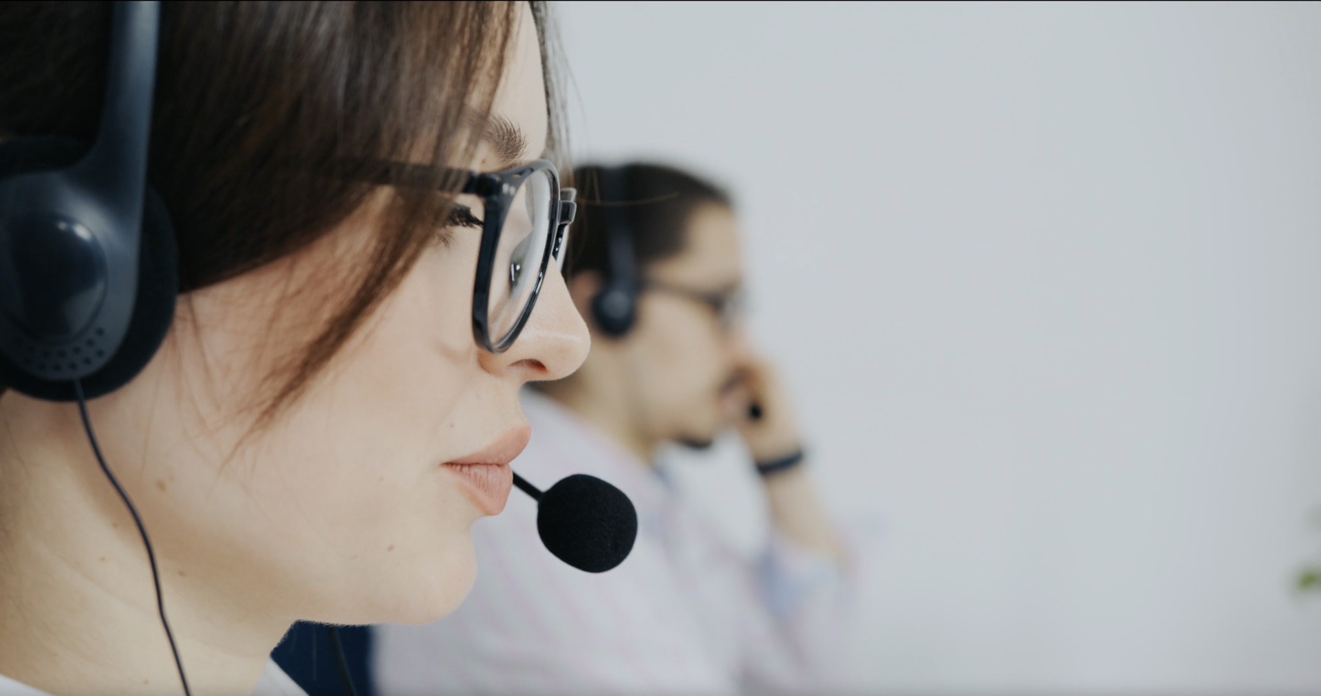 A receptionist with a headset on a call